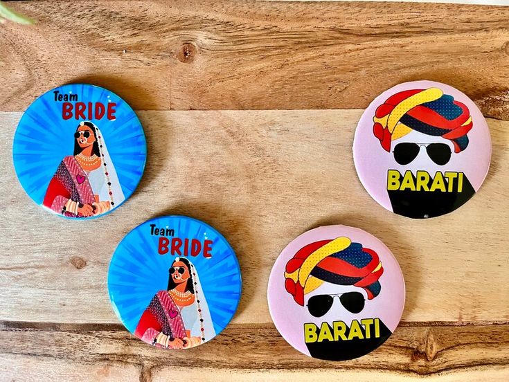 three button badges depicting the faces of two women, one with sunglasses on her head