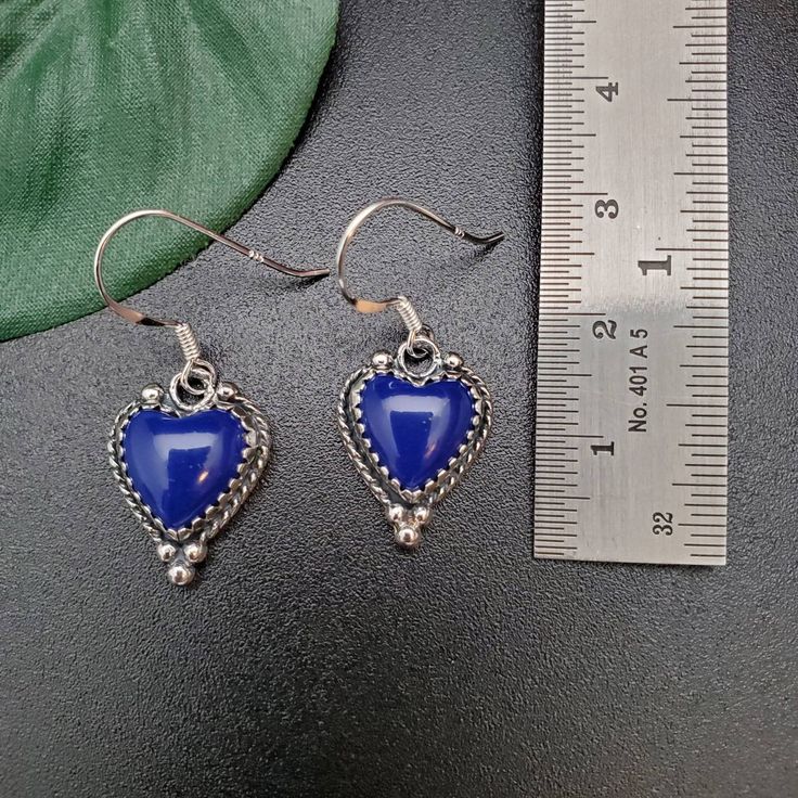 Visit our on-line shop at: Etsy.com/shop/AlbuquerqueDesigns *sterling silver earrings *dangles / drops / ear wires / hooks *southwestern jewelry *blue lapis lazuli *calibrated pre-cut stones: 10x10mm heart shape *back of jewelry items are all covered / do not show the back of stones *all jewelry items are made to ship, slight variations in stones will occur comparing to pictures. *size of a penny is 19mm or a dime is 18mm in diameter for comparing size with jewelry items. *handcrafted in USA *fr Valentine's Day Blue Heart Earrings, Blue Sterling Silver Jewelry With Heart Charm, Blue Heart Charm Earrings For Valentine's Day, Blue Heart-shaped Earrings For Valentine's Day, Blue Dangle Heart Earrings With Heart Beads, Blue Handmade Heart Drop Earrings, Blue Heart-shaped Earrings With Ear Wire, Handmade Blue Heart Drop Earrings, Blue Handmade Heart Dangle Earrings