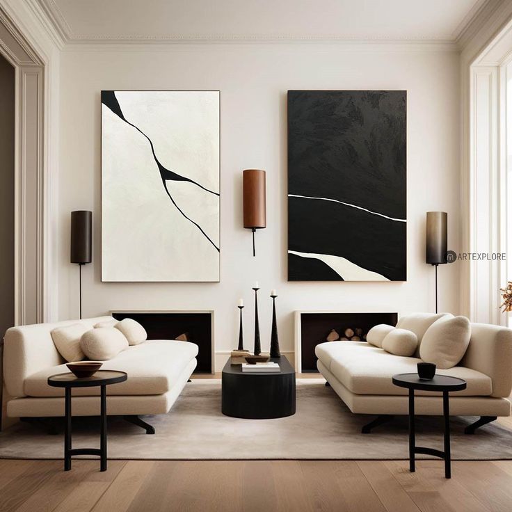 a living room filled with white furniture and paintings