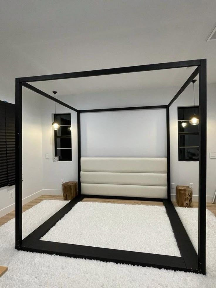 a bedroom with white carpet and black frame