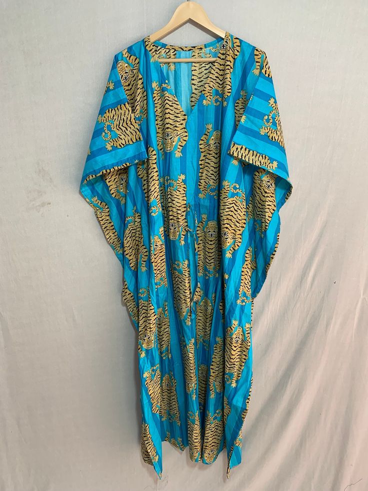 This Beautiful Indian Cotton Caftan or can be called as Tunic is made with super fine quality cotton and designs have been crafted by Hand Prints. Measurements :- Size - Free Size Length -138 Cm / 54 Inches Bust/chest size - 87 CM/ 34 Inches Fabric - 100% Cotton Pattern - Floral Kaftan has Adjustable Drawstring Waist to loose or tight , Kaftan has V Shape Neck Which is 8" Inches Deep. Kaftan Is Multi-purposeand can be worn as a cover up at the Beach ,Lounge wear ,sleepwear ,Pregnant Women Hospit Festive Floor-length Floral Print Kaftan, Silk Kaftan With Floral Print For Beach Cover-up, Long Caftan Dress, Blue Floral Embroidered V-neck Kaftan, Bohemian Floral Print Floor-length Kaftan, Silk Floral Print Kaftan For Beach Cover-up, Cotton Caftan, Silk Kimono Robe, Cotton Kaftan