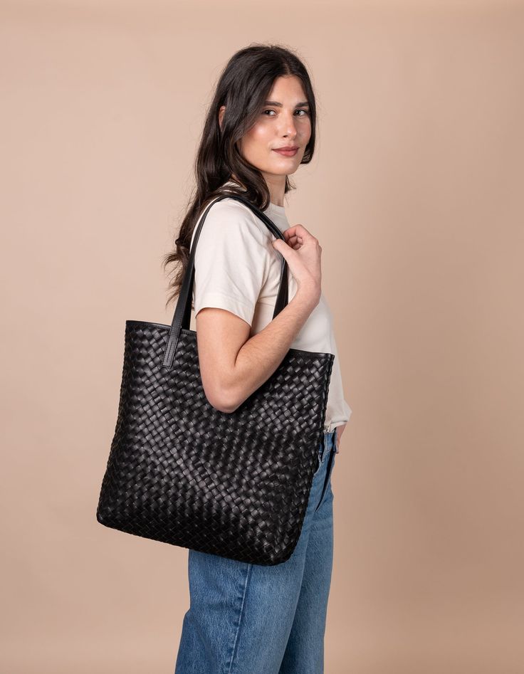 Model with Georgia bag in black woven classic leather Woven Leather Bag, My Bags, Work Opportunities, Sustainable Leather, Olivia Black, Small Village, Leather Weaving, Beach Picnic, Classic Leather