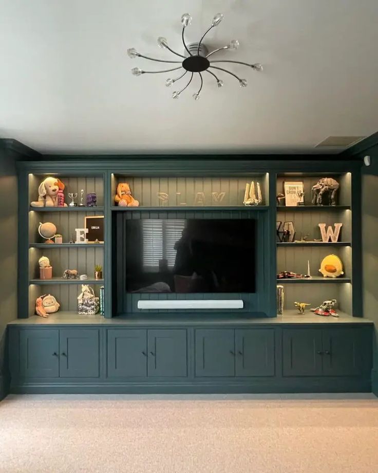 a living room with built in bookshelves and a television on top of it