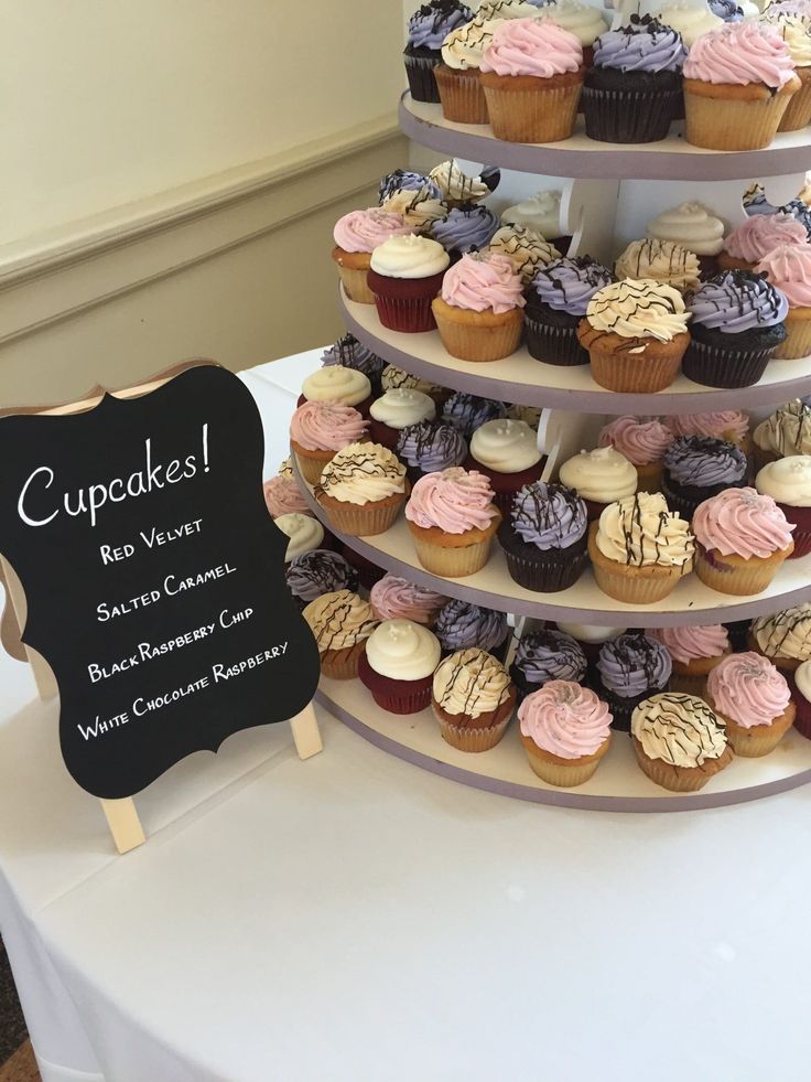 three tiered cupcake display with chalkboard sign