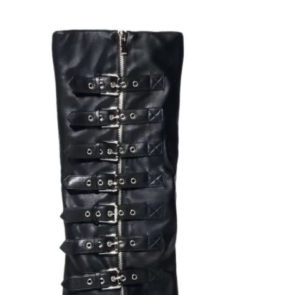 This Buckle Detail Wedge Boot In Black Is Made From A Faux Leather Upper And Features A Pointed Toe Silhouette, A Knee-High Shaft, And A Covered Wedge Heel. Complete With A Side Zipper Closure And Buckled Detailing. Trendy Faux Leather Wedge Boots For Party, Edgy Synthetic Boots With Buckle Closure, Edgy Pointed Toe Wedge Boots For Party, Punk Leather Boots With Wedge Heel, Black Faux Leather Wedge Heel Boots, Black Faux Leather Boots With Wedge Heel, Punk Style Leather Boots With Wedge Heel, Punk Leather Wedge Heel Boots, Chic Faux Leather Wedge Heel Boots