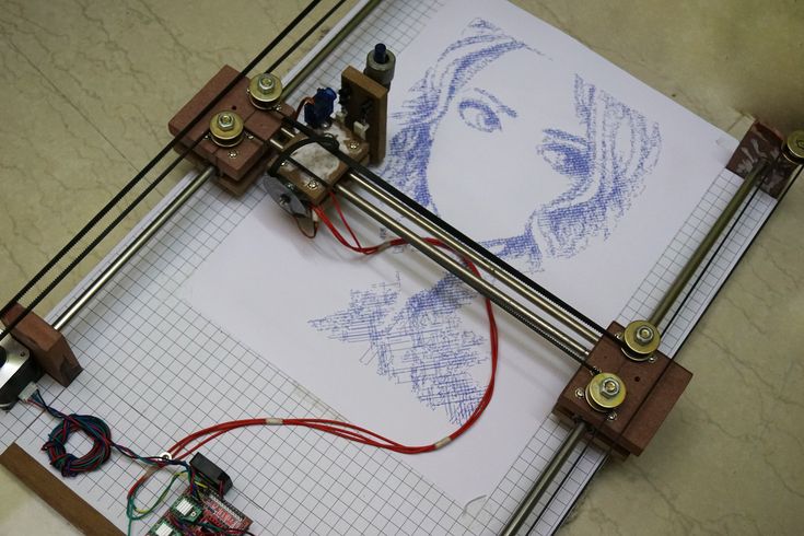 an image of a woman's face is shown on a piece of paper with wires attached to it