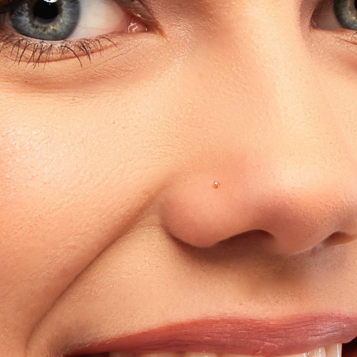 a close up of a woman's face smiling