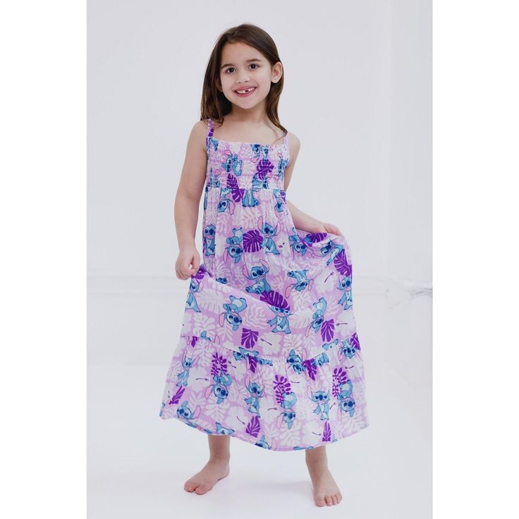 Get ready for a day filled with Disney magic in this stylish Disney maxi dress! This comfy and casual sundress features a fashionable smocked bodice, a pretty ruffle hem, and colorful Disney artwork your little girl will love to wear! Choose from a pink flower design with an all over print of Minnie Mouse and a purple Hawaiian design with artwork of Stitch from Lilo and Stitch. Made of a soft and lightweight material that keeps your child comfortable all day long, this cute Disney ruffle hem dre Summer Smocked Dress With Smocked Bodice For Playdate, Smocked Dress With Smocked Bodice For Summer Playdate, Summer Dress With Smocked Bodice For Playdate, Playful Summer Smocked Dress With Floral Print, Playful Smocked Floral Dress For Summer, Playful Floral Smocked Dress For Summer, Playful Smocked Dress With Floral Print For Summer, Playful Vacation Dress With Smocked Back, Playful Dress With Smocked Back For Vacation