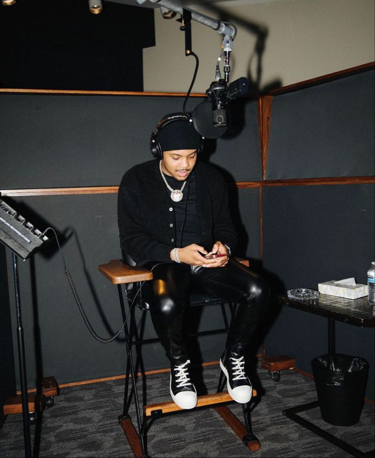 a man sitting in a chair with headphones on