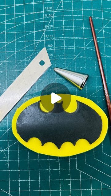 the bat symbol is cut out and ready to be put into a batman mask ornament