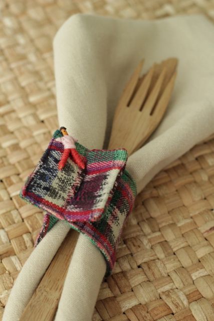 two wooden utensils are wrapped in fabric