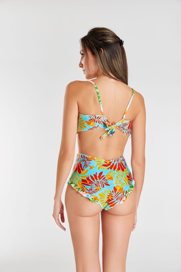 Make a statement with our eye-catching twist-front bikini set, designed to accentuate the bust and elevate your beach style. The high-waisted flutter bottom adds a playful touch to the ensemble. The padded strapless top not only ensures better support and durability but also features an adjustable string tying around the neck and a wider strap at the back for a secure fit. Enjoy the benefits of tummy control for a flattering silhouette. The classic brief sits comfortably across the middle of your hips, providing good coverage and a timeless look. Immerse yourself in this thoughtfully designed bikini set that effortlessly combines fashion, support, and comfort for a beach-ready look. Strapless Tropical Print Swimwear For Pool, Beachwear Swimwear With Twist Front And Underwire, Tropical Strapless Tankini For Vacation, Summer Underwire Swimwear With Twist Front, Underwire Twist Front Swimwear For Beachwear, Twist Front Underwire Swimwear For Beachwear, Twist Front Underwire Swimwear For Summer, Twist Front Underwire Swimwear For Beach, Summer Twist Front Underwire Swimwear