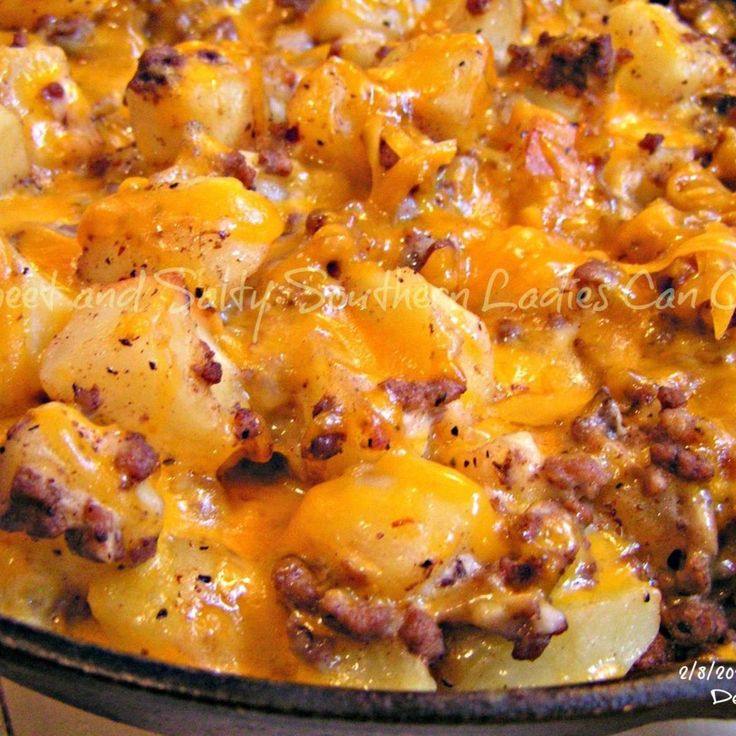 a casserole dish with potatoes, meat and cheese