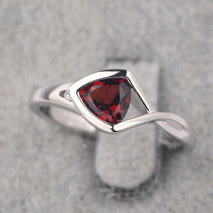 Ring details metal: silver/14k white(rose/yellow) gold center stone: trillion shape 6*6mm (0.93ct) garnet accent stone: cz NOTE: if it is silver or white gold, it will be get plated with rhodium Customization is available you can change, add or remove any parts of the ring if you have good idea. I can add special engraving inside the shank of the ring by free (words, date, simply simbles and so on) too. I am happy to help out or make any adjustments to your order if you have a special request. P Trillion Cut Birthstone Ring For Promise, Trillion Cut Birthstone Promise Ring, Trillion Cut Sterling Silver Ring With Gemstone, Trillion Cut Gemstone Birthstone Ring For Anniversary, Trillion Cut Birthstone Ring For Anniversary, Elegant Triangle Rings For Anniversary, Elegant Trillion Cut Birthstone Rings, Silver Trillion-cut Birthstone Ring, Silver Trillion Cut Gemstone Ring