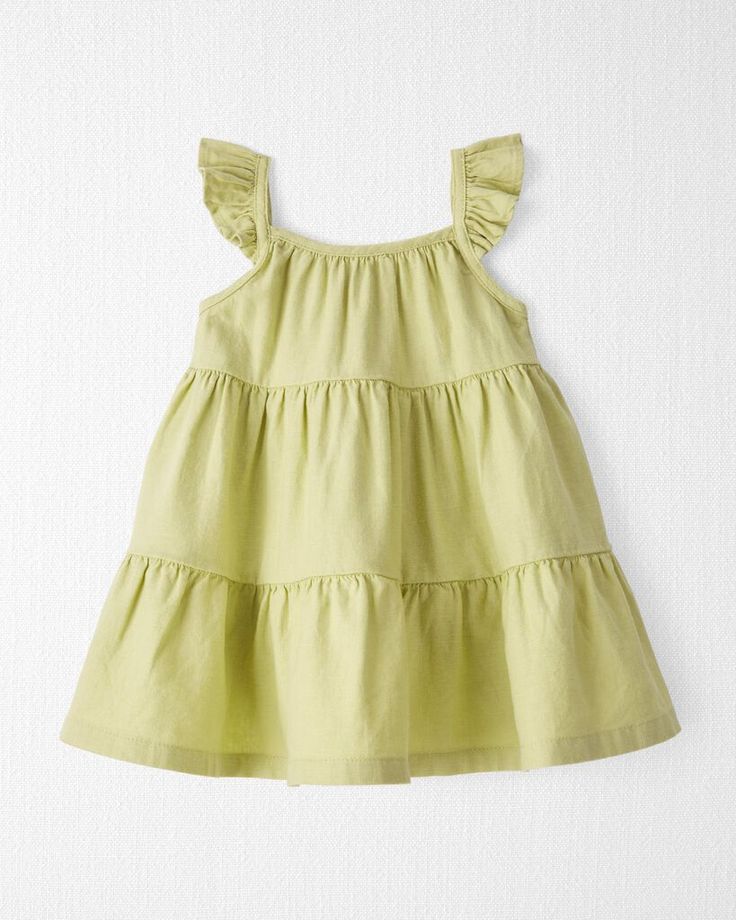 Crafted in soft LENZING™ ECOVERO™ and linen, this easy breezy sundress makes for a timeless summer style. With ruffle straps and an attached diaper cover, this tiny dress brings big charm that's gentle on baby and kind to our little planet. Crafted in the purest organic fabrics and sustainable materials, Little Planet is a return to simplicity. Thoughtful essentials and timeless pieces to gift or to hold on to. Solid Cotton Sundress For Summer, Solid Cotton Sundress For Spring, Cotton Tiered Dress With Adjustable Straps, Tiered Cotton Dress With Adjustable Straps, Cotton Sundress With Flutter Sleeves For Spring, Cotton Sundress With Tie And Ruffled Straps, Tiered Cotton Sundress With Adjustable Straps, Cotton Sundress With Ruffled Straps, Green Sundress With Ruffled Straps For Summer