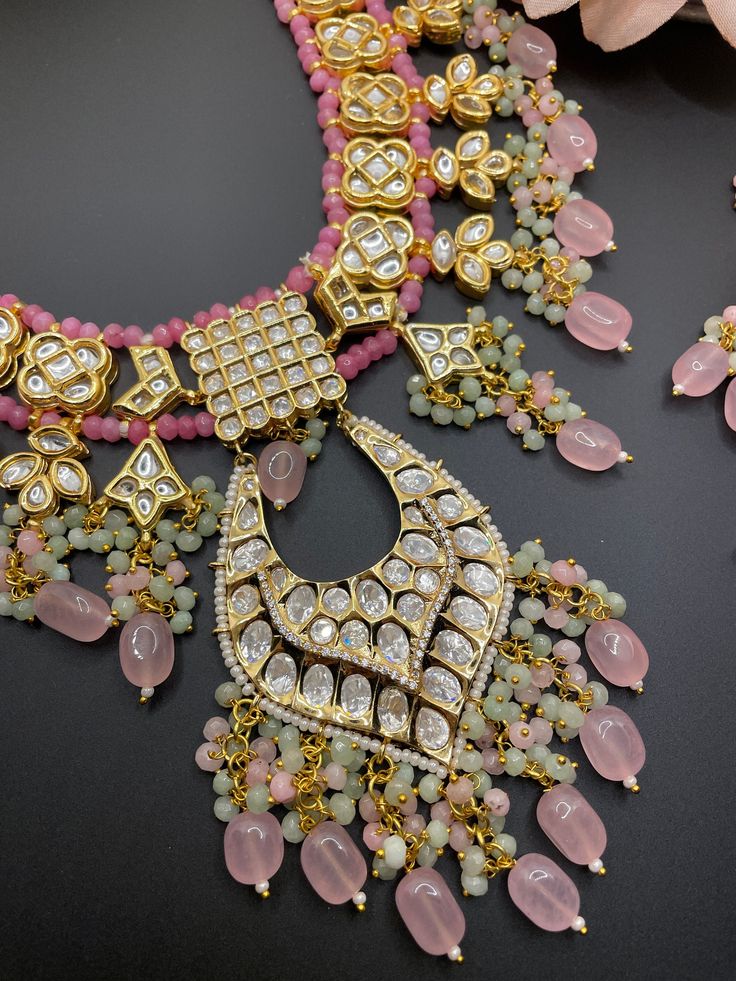 This adjustable long necklace is a very unique and fun piece for any event. The neutral gold and pastel pinks with polki work makes this the perfect statement set to wear! Comes with a matching pair of earrings Pink Kundan Fusion Jewelry, Diwali Party Necklace With Gota Work, Festival Jewelry With Gota Work For Designer Wear, Kundan Long Necklace For Party, Pink Meenakari Necklaces For Festive Occasions, Hand Set Pink Necklace For Celebrations, Pink Hand Set Necklace For Celebration, Pink Hand-set Necklace For Celebrations, Pink Kundan Necklaces For Gifts