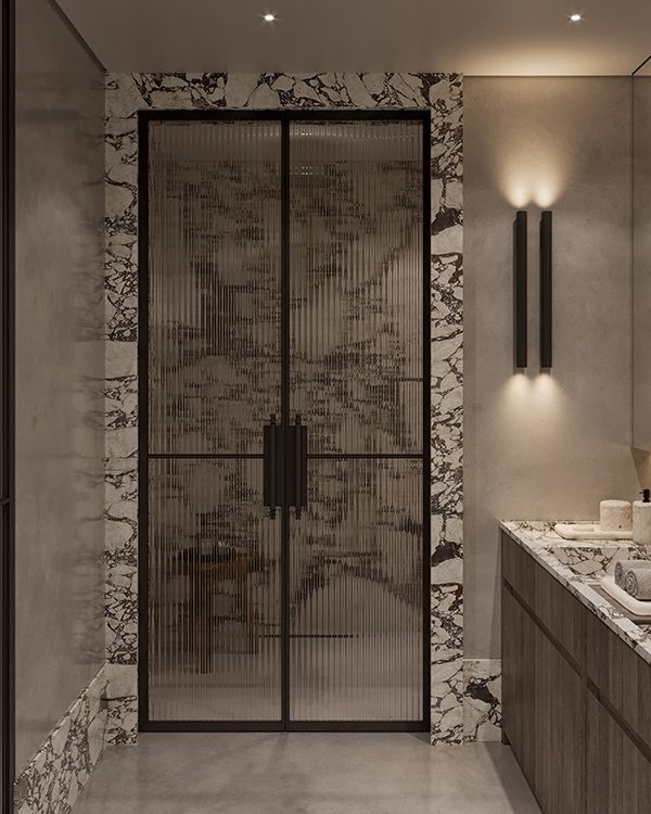 a bathroom with two sinks and a large glass door in the wall next to it