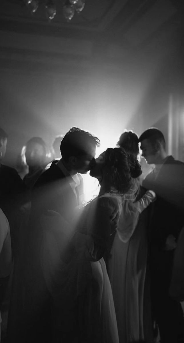 black and white photograph of people standing in a room