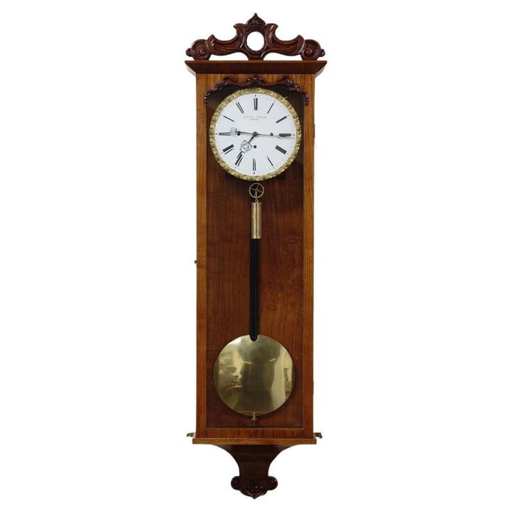 a grandfather clock with pendulum on the wall