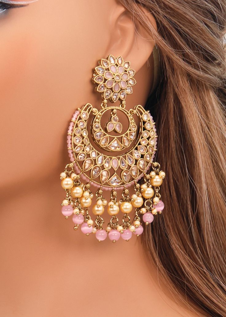 These Polki earrings are a classic addition to any traditional outfit with their stunning stones, crystals, and pearls. They add an exquisite charm and make for the perfect accessory to complete your look. Earrings length: Approx. 3.5" Weight of each earring: 31 gms Push-Back Closure. Antique Gold Plated on high-quality brass as the base metal In-stock & ready-to-ship Color may vary slightly due to light condition & photography. Jewelry Care: Keep away from moisture. Allow perfumes and lotion to Luxury Chandbali Pearl Earrings For Party, Luxury Bridal Earrings With Latkans For Parties, Luxury Heavy Kundan Bridal Earrings, Luxury Round Meenakari Bridal Earrings, Elegant Luxury Earrings For Navratri, Luxury Diamond Earrings With Latkans, Luxury Kundan Jhumkas With Tilla, Luxury Chandbali Gemstone Earrings, Luxury Chandbali Jewelry Sets With Latkans