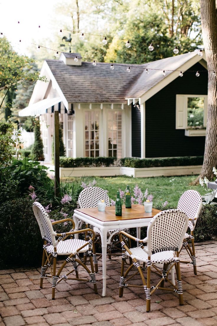 the instagram page shows an image of a table and chairs in front of a house