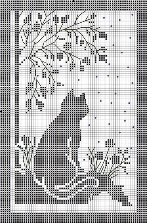 a cross stitch pattern with a monkey on it's back and branches in the background