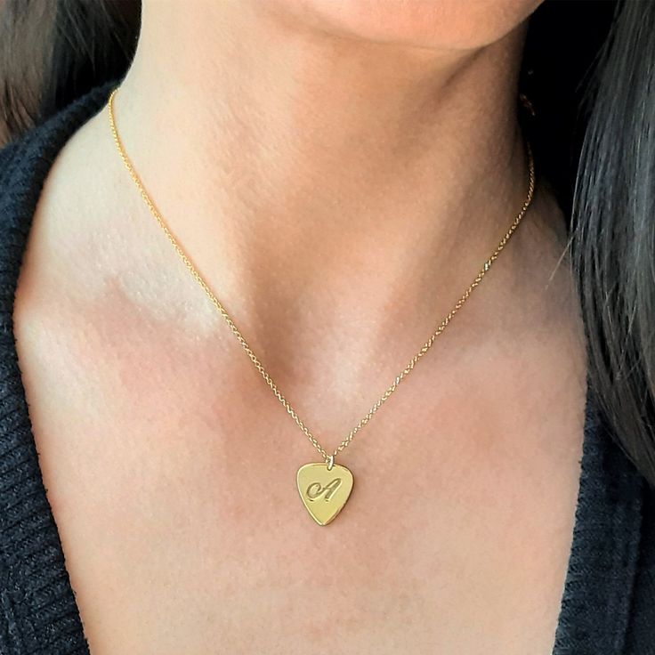 This is the piece of jewelry to get for every Rock lover. This Guitar pick necklace the perfect gift for guitarists ,music lovers, and for every musician. The necklace is totally handmade the base material is 14k or 9k Solid Gold,White or Rose gold Metal information and dimensions details: ---------------- Width : 17.00mm x 14.50mm Metal: Solid 9K Yellow ,White or Rose gold or Solid 14K Yellow ,White or Rose gold Solid gold chain 9k Yellow,White or Rose gold or Solid gold chain 14k Yellow,White Adjustable Engraved Heart Necklace Gift, Engraved Adjustable Heart Necklace Gift, Heart-shaped Music-themed Jewelry Gift, Music-themed Heart-shaped Jewelry Gift, Personalized Gold Music-themed Jewelry, Music-themed Pendant Necklaces As Gift, Music-themed Pendant Necklace As Gift, Music-themed Pendant Jewelry For Gifts, Music-themed Pendant Jewelry As Gift