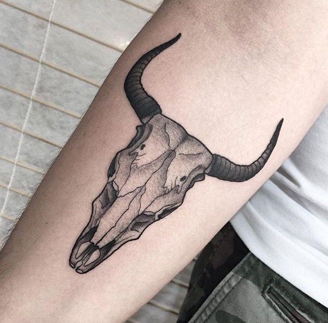 a bull's head tattoo on the arm