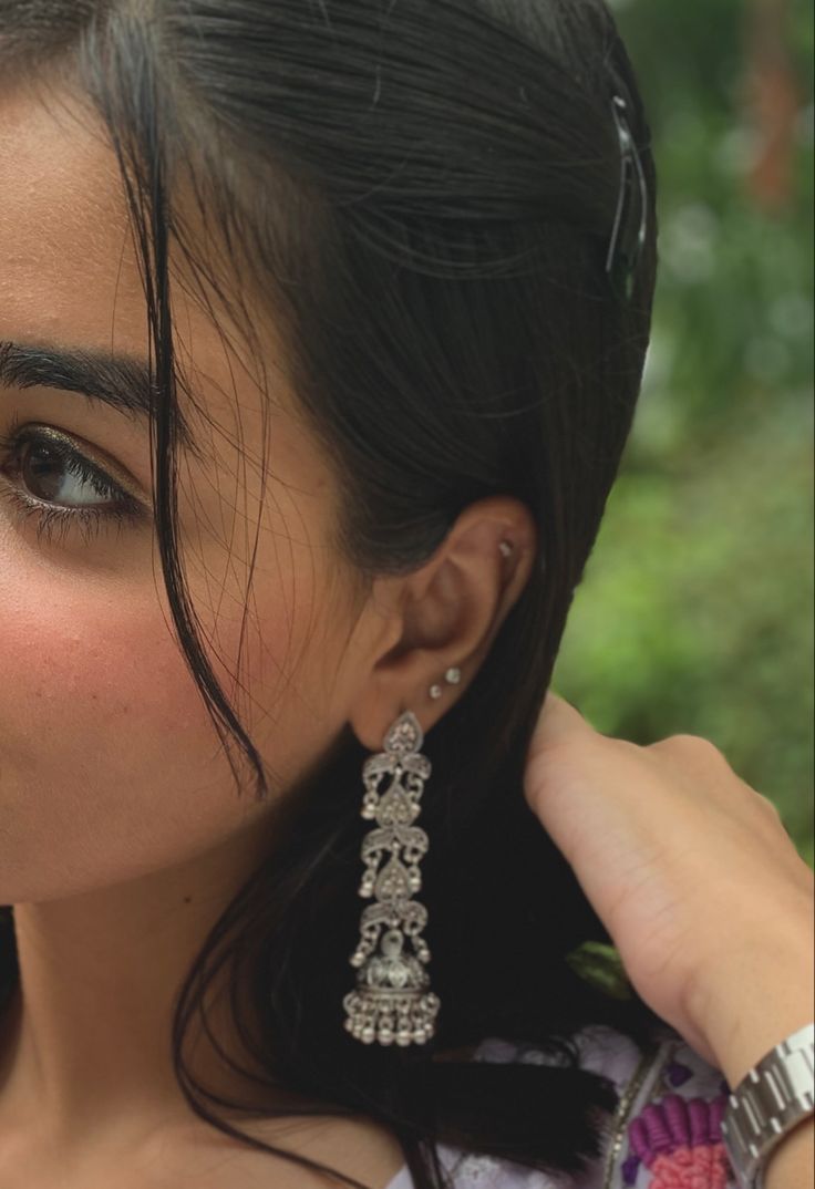 a close up of a person wearing earrings