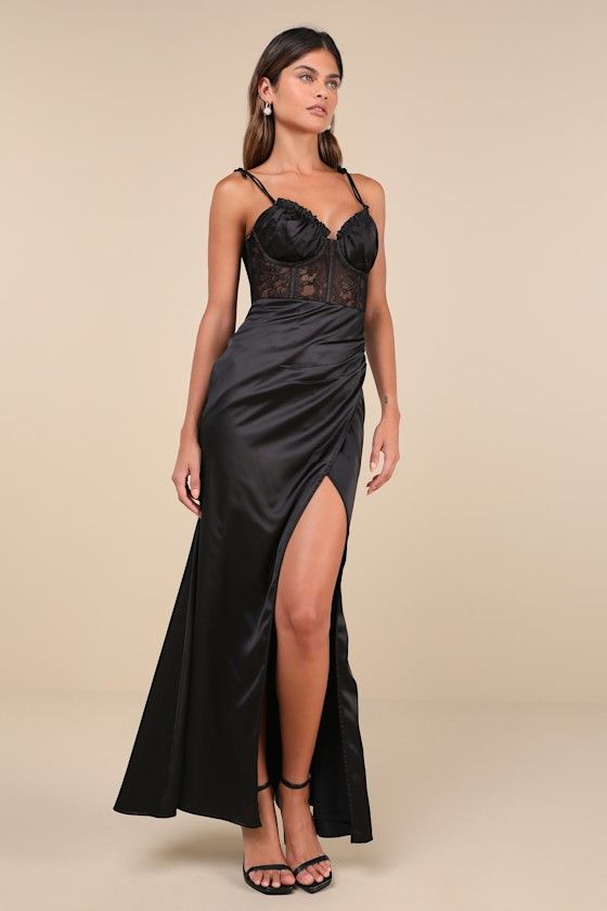 Enchant everyone you meet the moment they see you in the Lulus Spellbinding Aura Black Satin Lace Tie-Strap Bustier Maxi Dress! Sleek woven satin shapes this head-turning dress that falls from tying spaghetti straps into a ruffled, sweetheart neckline and a sheer lace, bustier-style bodice with gathered satin cups and supportive boning. High, fitted waist tops a flattering tulip-style maxi skirt with pleated gathering at the side. Turn around to reveal a flirty lace-up detail at the back. Hidden Black Satin Dresses With Boning, Gala Corset Dress With Spaghetti Straps And Lined Bodice, Gala Corset Dress With Spaghetti Straps, Black Satin Slip Dress For Prom, Sleeveless Satin Dress With Boning, Backless Satin Slip Dress With Boning, Evening Slip Dress With Delicate Straps And Fitted Bodice, Satin Slip Dress With Fitted Bodice For Gala, Satin Finish Slip Dress With Fitted Bodice For Prom