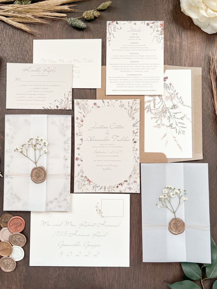 the wedding stationery is laid out on a table