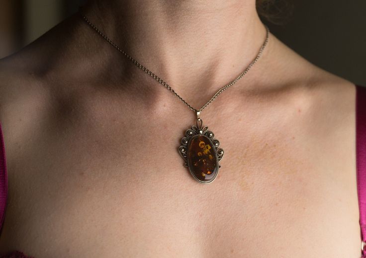 Amazing pendant with heated amber and chain 42 cm! Very elegant and luxurious piece of jewelry. All our items have been handmade with love and care more than 35 years ago by our family member - uncle Alfreds Holsts using the amber which Alfred acquired in his lifetime from the coast of the Baltic Sea (from 40,000,000 to 60,000,000 years old), which is the best-known and called succinite amber for containing a substantial amount of succinic acid. As the amber is as nature has made it - unique, it Handmade Baltic Amber Pendant Necklace, Baltic Amber Pendant Necklace, Amber Pendant Necklace In Baltic Amber, Oval Baltic Amber Necklace, Cabochon Baltic Amber Necklace As Gift, Baltic Amber Cabochon Necklace For Gift, Baltic Amber Necklace With Round Pendant, Elegant Handmade Baltic Amber Necklaces, Amber Pendant Necklace With Cabochon