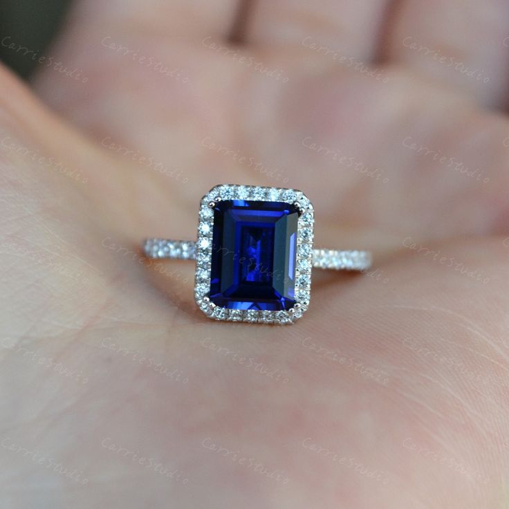 Halo Emerald Cut Blue Sapphire Engagement ring, material 925 sterling silver, plated with white gold, can wearing with diffferent bands, to make your unique match. Main Stone: Lab Created Sapphire Cut: Emerald Measurerment: 7*9 mm, about 2.5ct Side Stone: CZ CS0393 With different bands: https://www.etsy.com/listing/1074591876/halo-emerald-cut-blue-sapphire-ring?ref=shop_home_active_14&pro=1&frs=1 Gia Certified Blue Jewelry For Gift, Blue Gia Certified Jewelry For Gift, Blue Emerald Cut Rings With Vs Clarity, Emerald Cut Blue Jewelry For Anniversary, Blue Sapphire Emerald Cut Jewelry, Emerald Cut Blue Sapphire Jewelry, Emerald Cut Halo Sterling Silver Jewelry, Blue Emerald Cut Sapphire Jewelry, Gia Certified 14k White Gold Blue Jewelry