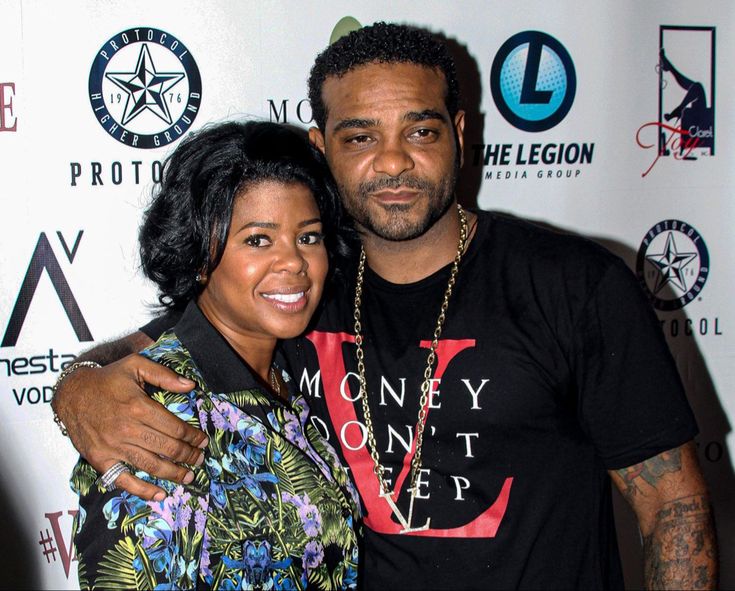 a man standing next to a woman on a red carpet