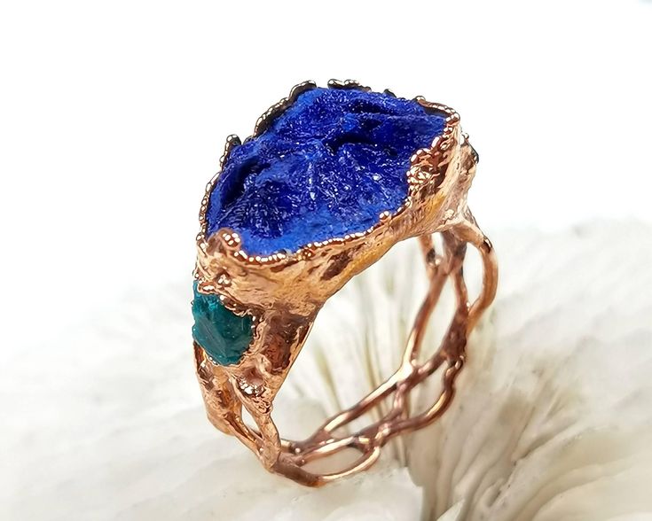 DETAILS  ★ US size: 9 3/4; ★ British: T 1/4; ★ Inside diameter: 19.62mm; ★ Inside circumference: 61.64mm; ★ Azurite crystal cluster ★ Special braided ring band ★ Electroformed and electroplated with copper ★ Naturally oxidized ★ Coated with protective lacquer to protect patina layer and to reduce chance of finger staining (green fingers) ★ What you see is what you get ★ International Shipping available worldwide! ★ Gift ready packaging Electroformed Jewelry is the combination of art and science. Handmade Blue Emerald Ring For Anniversary, Handmade Blue Crystal Ring With Unique Style, Handmade Emerald Ring Gift, Handmade Unique Blue Crystal Ring, Unique Blue Crystal Ring For Anniversary, Handmade Blue Emerald Anniversary Ring, Handmade Aquamarine Blue Rings, Unique Blue Crystal Round Ring, Handmade Blue Aquamarine Rings