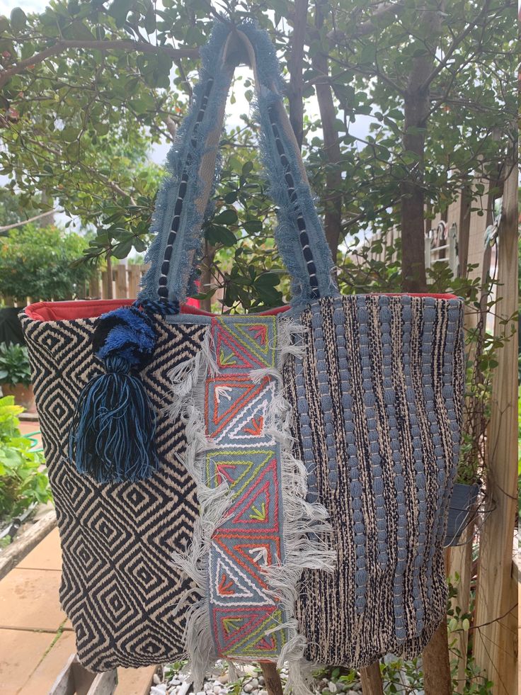 "Peruvian Cotton Ethnicity Artisan Blue Tones Tote Bag Handmade with beautiful details Oversized silhouette. features a Canvas cotton build with an open top and dual carry handles. Raw cotton Embroidered . The tote has three inside pockets, with one including a zipper. Each have a tie closure and plenty of room to carry all your vacation essentials. Plain Blue Denim Back. Cotton Oversized Tassel Features: - 100% Natural Cotton - Made in Peru - Canvas Coated - Machine Wash Size - Height: 20\" - W Vacation Essentials, Plain Blue, Tote Bags Handmade, Oversized Silhouette, Bag Handmade, Fort Myers, Blue Tones, Open Top, Natural Cotton