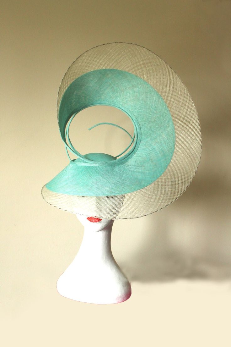 Hat Title - The Swirl (in green and ivory) An architectural shape that sits proud on the head of the wearer. Handmade with mint sinamay and outlined with checkered windowpane in ivory. The back of this hat is equally unique. Each angle of the hat looks different, providing different perspectives to the viewer. The hat adheres to your head via a millinery elastic.  This hat and almost all of my hats can be made in colours of your choice. Message me to discuss. The last photo shows this hat in Black and Gold. Luxury Green Wedding Costume Hats And Headpieces, Elegant Green Headpiece For Church, Elegant Green Short Brim Headpieces, Elegant Green Adjustable Costume Hats And Headpieces, Green Top Hat For Spring Church Occasion, Elegant Green Adjustable Hat, Green Top Hat For Summer Church Events, Green Top Hat For Church In Spring, Adjustable Green Top Hat For Spring