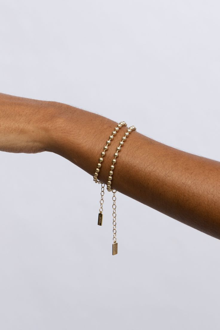 Like the popular lifestyle blogger Amy Jackson for which it was named, the Fashion Jackson Bracelet emits an air of classy sophistication. Featuring an endless chain of luminous rounded gold beads, this piece has become everyone's must-have bracelet. Dress it up or down—the options are endless. STYLING TIP: Get Amy's look! Pair it with our best selling London Bracelet. 18k gold-plated sterling silver or sterling silver 4mm beads Available in 4 lengths 5.5" plus 1.5" extender 6.5" plus 1.5" exten Minimalist Gold Tennis Bracelet, Minimalist Gold Tennis Bracelet For Everyday, Minimalist Gold Plated Round Beads Bracelets, Minimalist Gold Plated Bracelets With Round Beads, Minimalist Gold Plated Round Beads Bracelet, Elegant Gold Bracelet With Beaded Chain, Elegant Ball Chain Bracelet, Minimalist Gold Tennis Bracelet With Adjustable Chain, Gold Minimalist Tennis Bracelet With Adjustable Chain