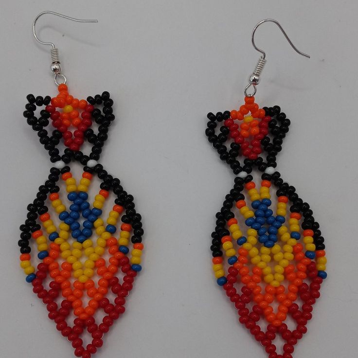 Chaquira Earrings Typical Amazon Jungle In The Shape Of Geometric Figures Handmade By Peruvian Artisans, The Beads Are Multicolored Plastic Beads. Multicolor Pattern Colors That Vary From Piece To Piece. These Earrings Are Handmade By Peruvian Artisans In The Amazon Jungle Traditional Black Beaded Earrings, Handmade Black Jewelry For Festivals, Traditional Orange Jewelry With Black Beads, Artisan Black Jewelry For Festivals, Multicolor Traditional Beaded Earrings, Multicolor Earrings With Black Beads For Gift, Multicolor Earrings With Black Beads, Traditional Red Earrings With Black Beads, Orange Earrings With Black Beads As Gift