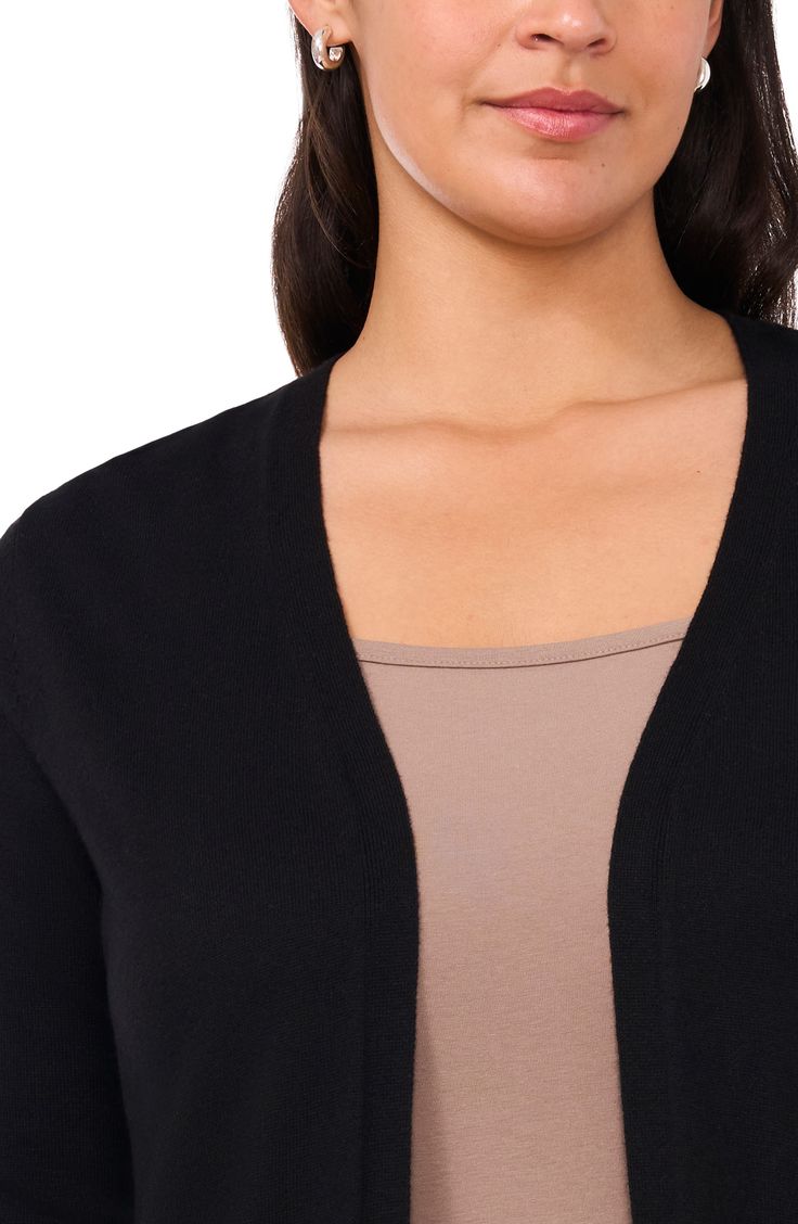 This cotton-softened cardigan is knit in a flowy, longline silhouette with side slits and features handy front pockets. 37" length (size 3X) Open front Long sleeves Ribbed cuffs and hem Front patch pockets Side slits 40% viscose, 40% nylon, 20% cotton Machine wash, dry flat Imported Classic Black Cardigan For Daywear, Black Casual Cardigan For Daywear, Casual Black Cardigan For Daywear, Black Cardigan For Daywear, Black Casual Daywear Cardigan, Black Relaxed Fit Cardigan For Layering, Versatile Black Cardigan For Everyday, Versatile Black Cardigan For Daywear, Versatile Everyday Black Cardigan