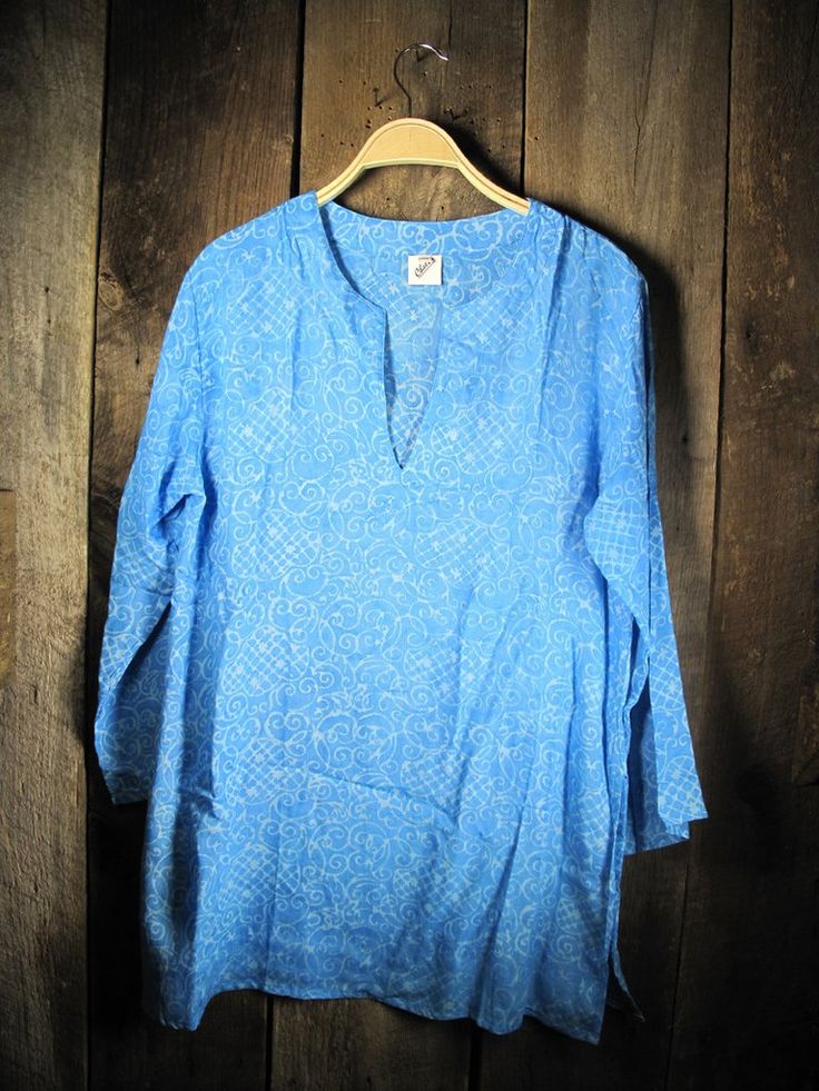 Blue rayon Batik tunic printed using a wax dye technique creating an interesting pattern that can be used as a beach cover-up. 100% rayon fit really depends on Spring V-neck Kaftan With Batik Print, Blue Printed V-neck Cover-up, Blue V-neck Festival Cover-up, Block Print V-neck Tops For Summer, Summer V-neck Tops With Block Print, Tie Dye V-neck Top For Beach, Hippie V-neck Beach Tunic, Beach Hippie V-neck Tunic, Printed V-neck Tunic