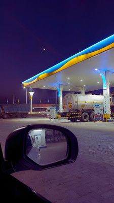 a gas station at night with the lights on