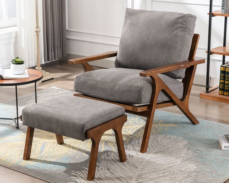 a chair and ottoman in a living room with a rug on the floor next to it