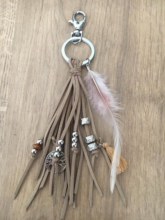 a key chain with feathers and charms on it