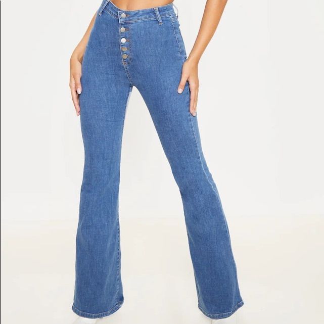 These Jeans Are Sure To Give Your Look A Vintage Vibe. Featuring A Mid Wash Denim Material With A High Waisted Fit, Button-Down Design And Flared Leg, Team With A Crop Top And Heeled Boots For A Look We Are Loving. Length Approx 86.5cm/34" (Based On A Sample Size Uk 8) Model Wears Size Uk 8/ Eu 36/ Aus 8/ Us 4 Model Height - 5ft 9" Blue Mid-rise Flare Jeans With Button Closure, Fitted Denim Blue Bottoms With Snap Buttons, Fitted Denim Blue Flare Jeans With Buttons, Blue Button-up Summer Pants, High Waist Flare Jeans With Buttons In Denim Blue, High Waist Denim Blue Flare Jeans With Buttons, Blue High Waist Buttoned Flare Jeans, High Waist Blue Flare Jeans With Button Closure, Blue High Waist Flare Jeans With Buttons