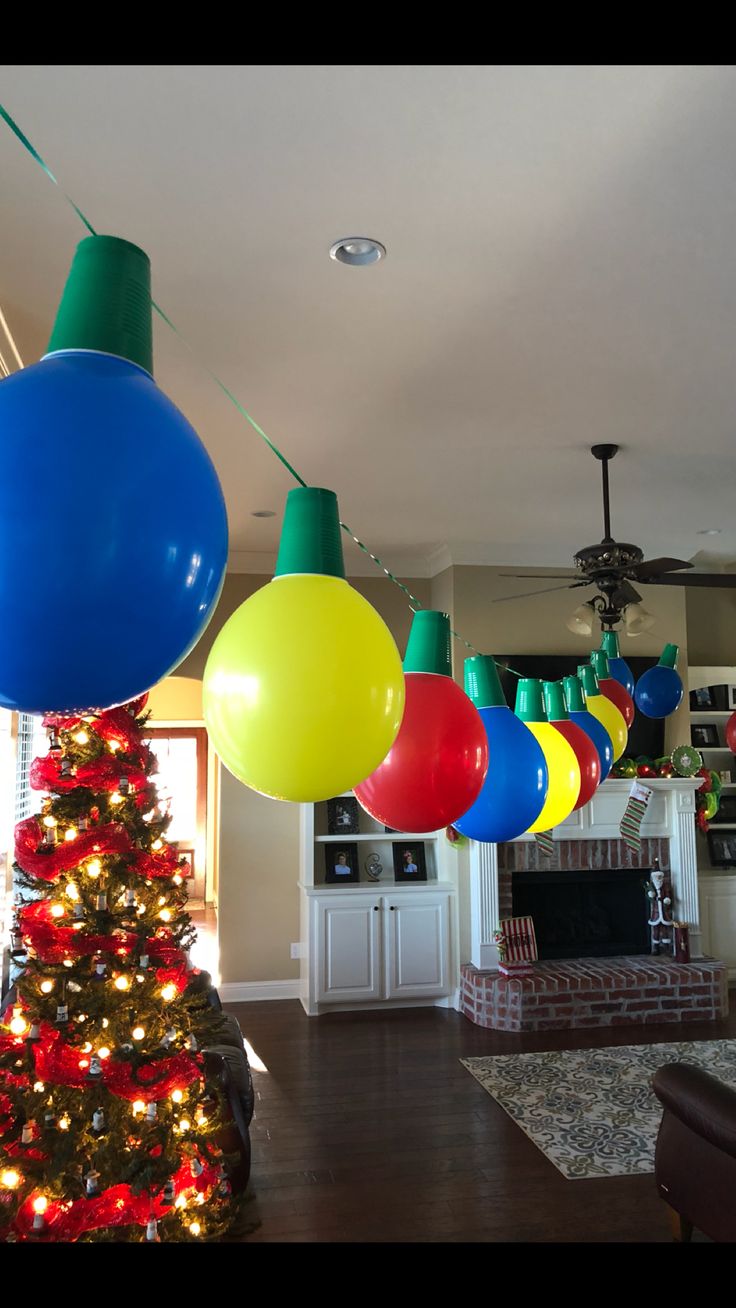 a christmas tree with balloons hanging from it