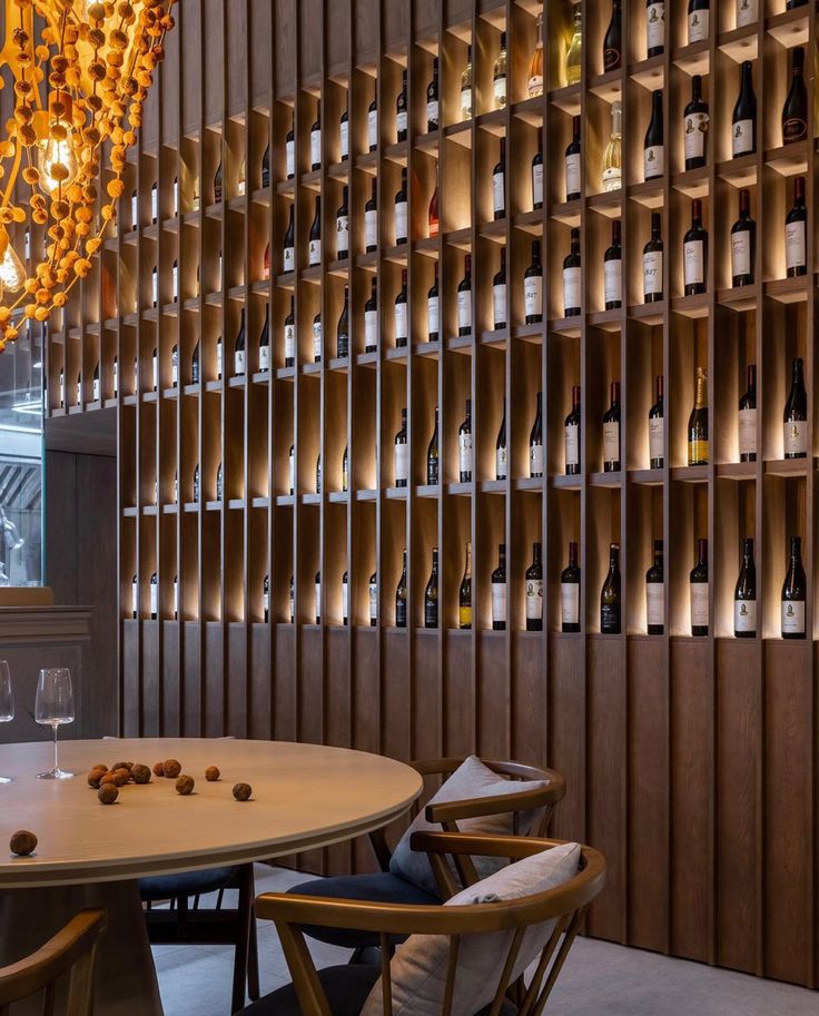 a wine cellar with wooden shelves and chandelier