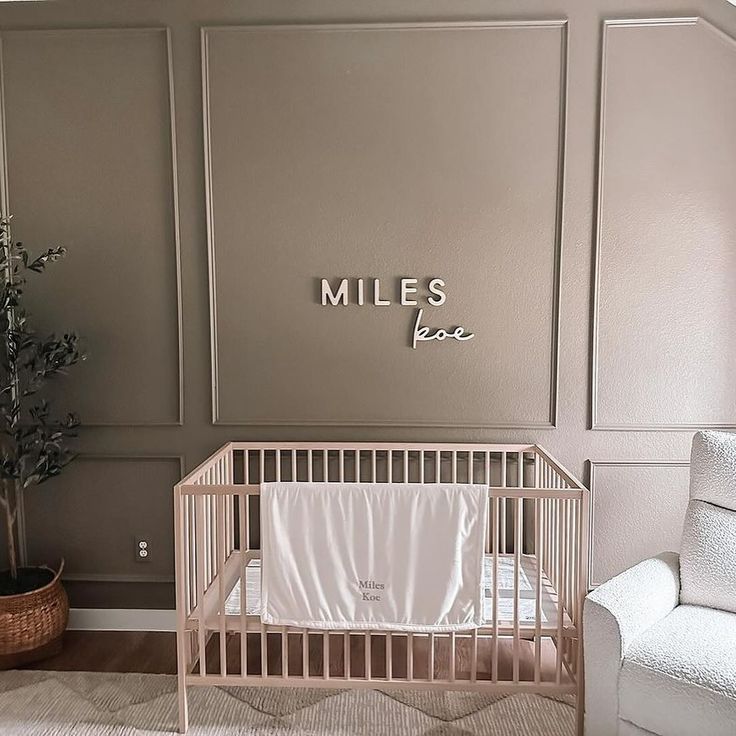 a baby's room with a white crib and gray walls