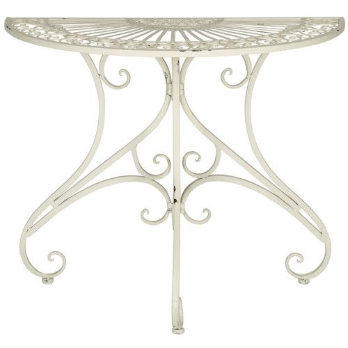 a white metal table with an intricate design on it's top and bottom edge