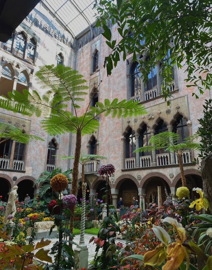 the inside of a building with lots of plants and flowers